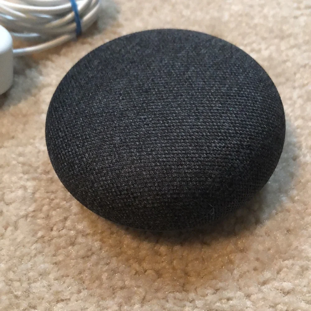 Google nest smart speaker with charger.